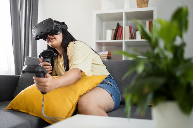 Young person playing videogames with vr glasses