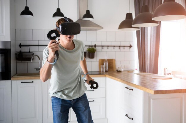 Young person playing videogames with vr glasses