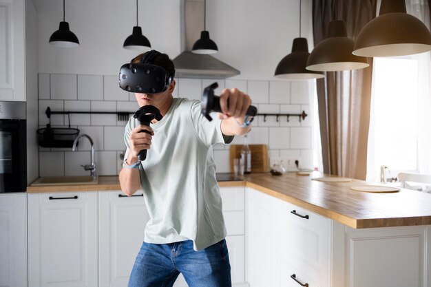Young person playing videogames with vr glasses