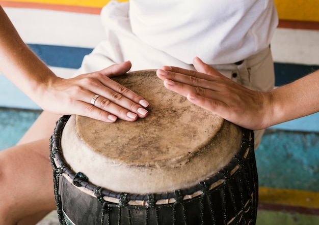 Free photo young person playing yuker drum