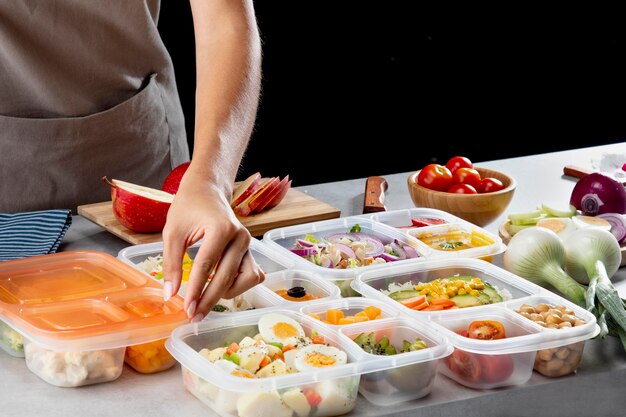 Young person practicing batch cooking with healthy food