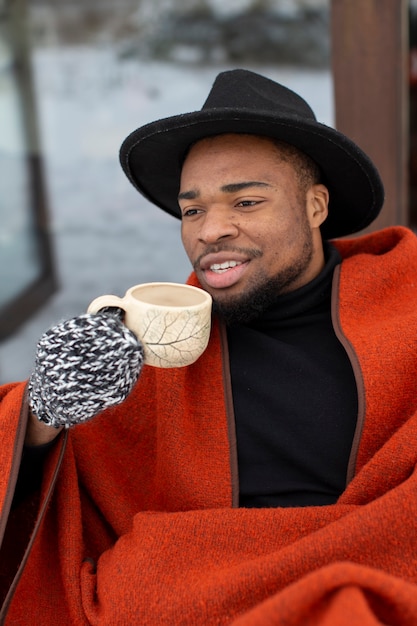 Free photo young person relaxing with hot coffee