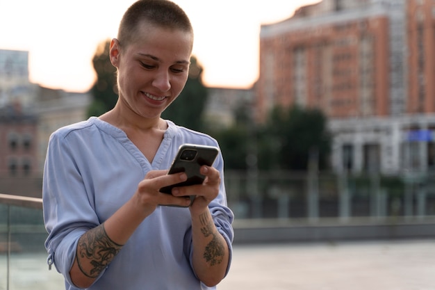 Young person with less fingers holding her phone