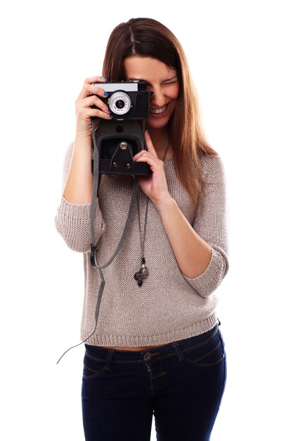 Young photographer woman with vintage analog camera