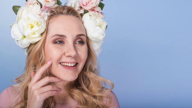 Free photo young pleased blond lady with beautiful flower wreath