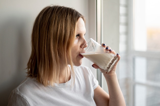 young pregnant woman drinking milk