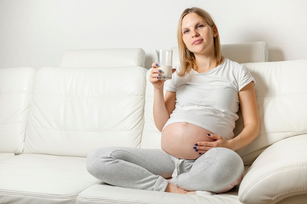 Young pregnant woman drinking milk