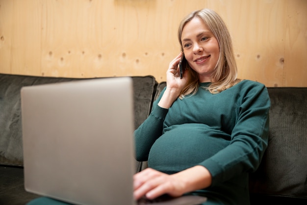 Free photo young and pregnant woman at work