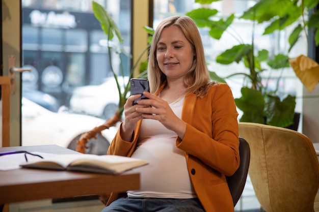 Free photo young and pregnant woman at work