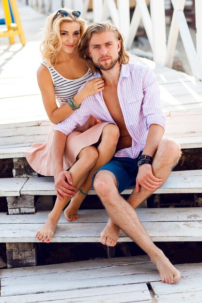 Young pretty blonde woman and handsome man hugs outdoor, having great time at their romantic date