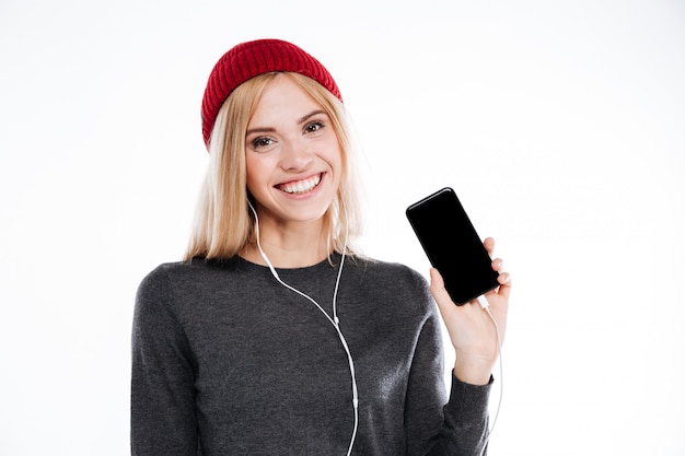 Young pretty cute young woman with earphones listening music