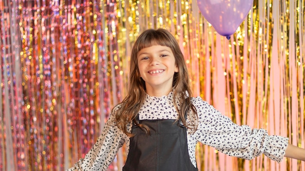 Young pretty girl at festive party with balloons