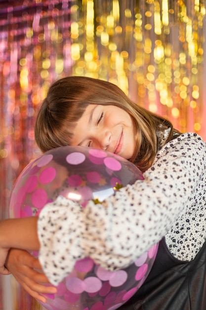 Young pretty girl at festive party with balloons