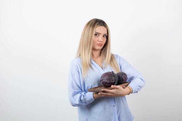 young pretty girl model standing and holding cabbage. 