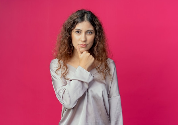 young pretty girl putting hand under chin 