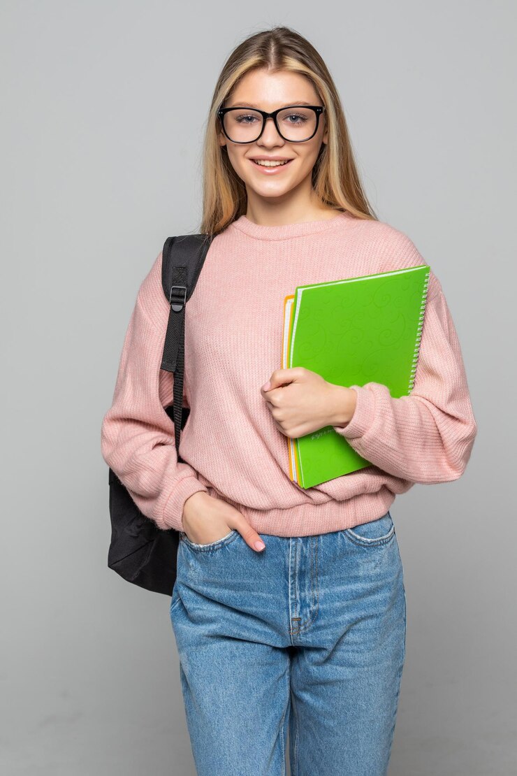 Free Photo young pretty student woman posing isolated over white wall