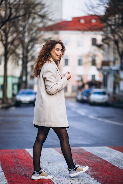 Young pretty woman on a crosswalk