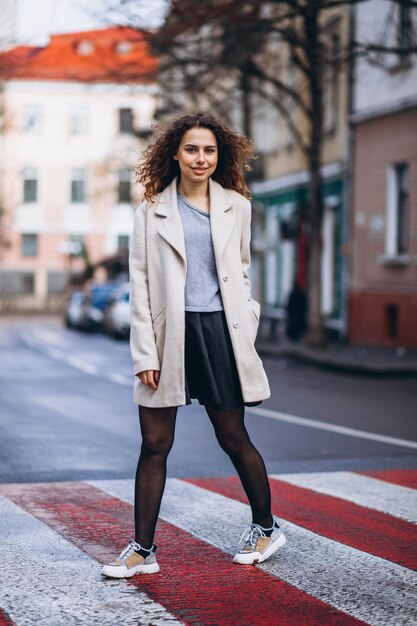 Young pretty woman on a crosswalk