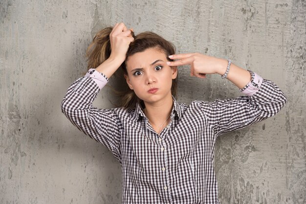 A young pretty woman holding hair in ponytail