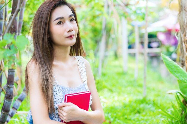 Young pretty woman hug a diary in arm