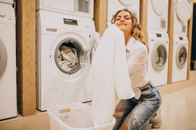 Young pretty woman at a laundrette