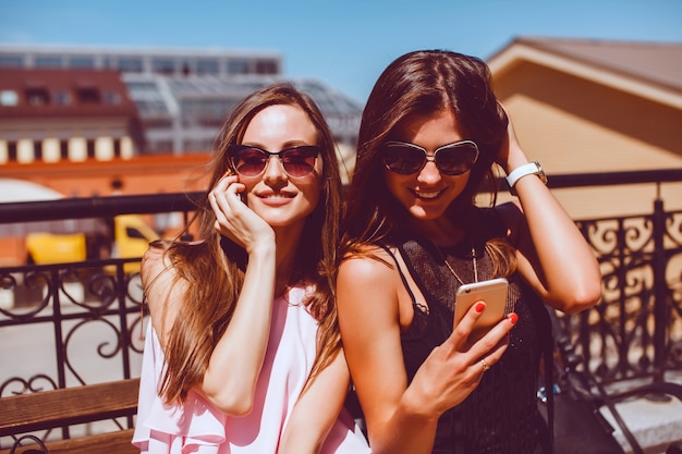 young pretty woman posing in the street with phone