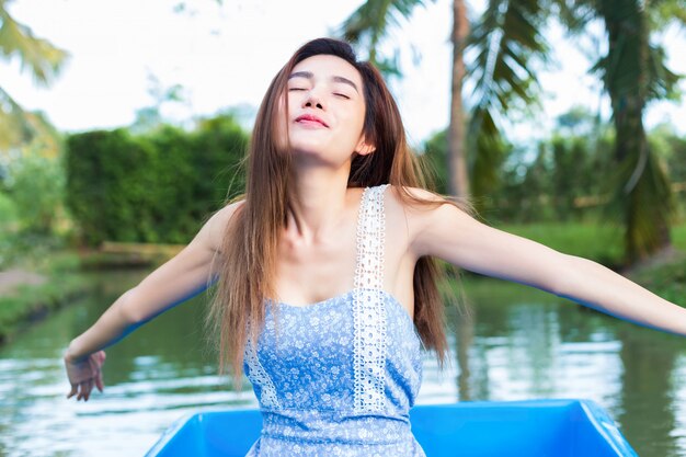 Young pretty woman relaxing by paddling boat