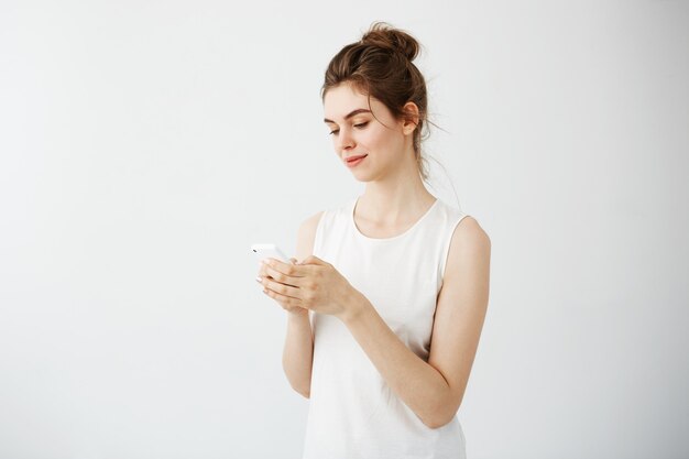 Young pretty woman smiling looking at phone