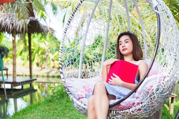 Young pretty woman with red diary in park