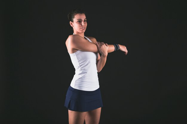 Young professional player warming up her arms