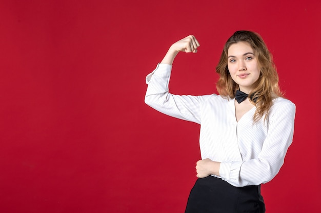 young proud waitress woman butterfly on the neck and showing her muscle on red background