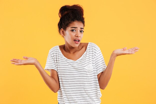 Young puzzled woman and doesn't know what to do isolated