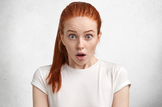 Free photo young red-haired woman with white t-shirt