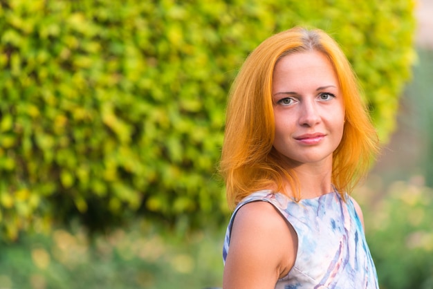 Young red woman on a bench