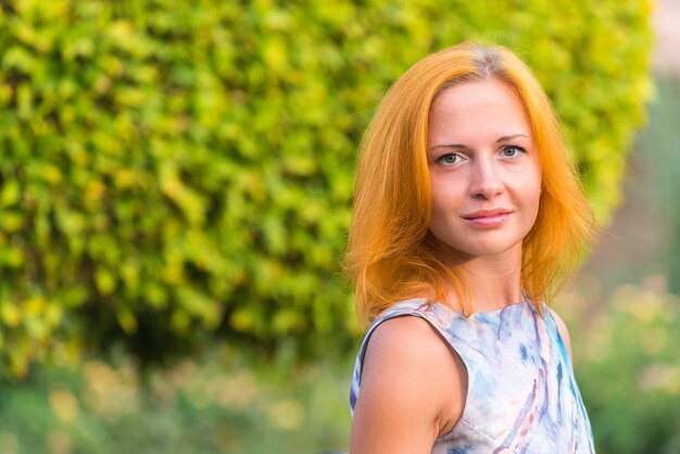 Young red woman on a bench