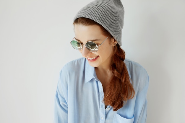 Young redhead girl wearing sunglasses and hat