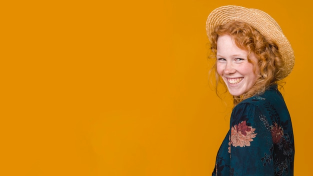 Young redhead half turned woman toothy smiling 