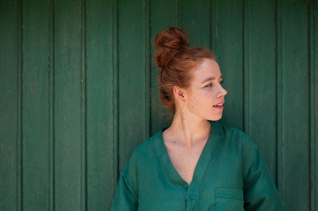 Free photo young redhead woman looking away