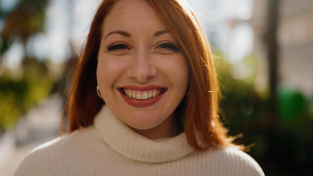 Young redhead woman smiling confident standing at park