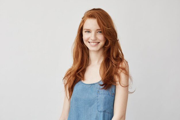 Young redhead woman smiling.