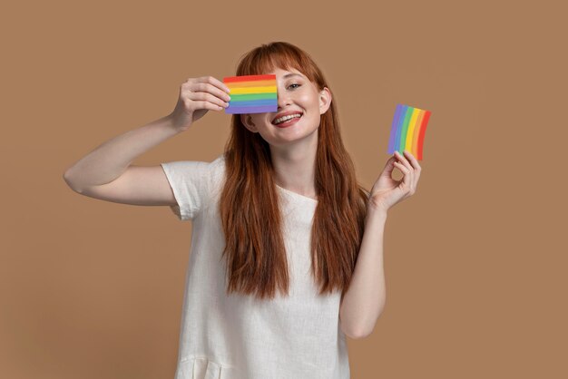 Young redhead woman with rainbow symbol