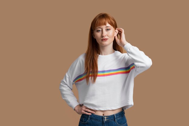 Young redhead woman with rainbow symbol