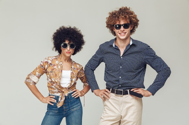 Young retro loving couple posing isolated