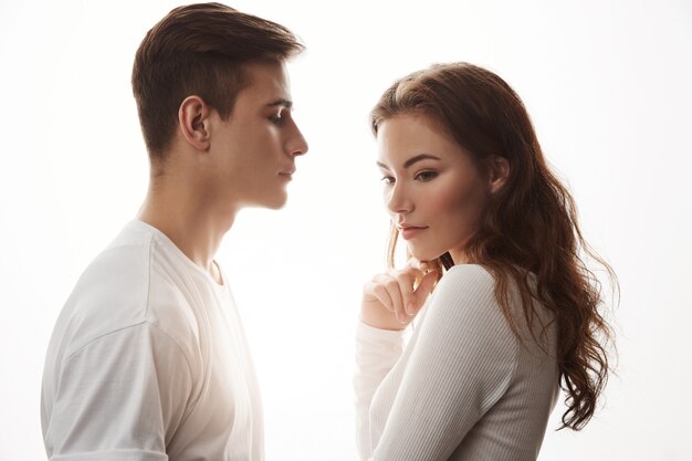 Young romantic couple in love standing in front of each other.