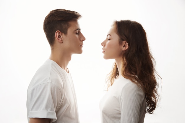 Young romantic couple in love standing in front of each other.