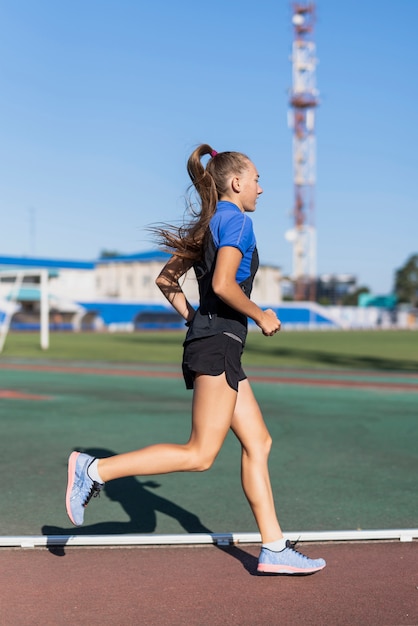Young runner woman at stadium
