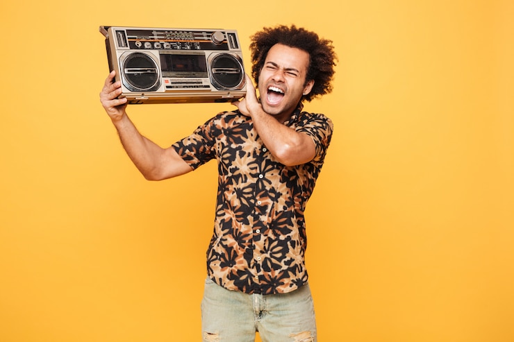 Free Photo young screaming african man standing with tape recorder