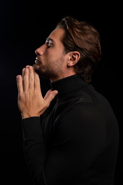 Young and sensitive man praying