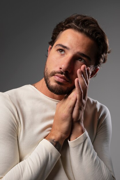 Young and sensitive man praying