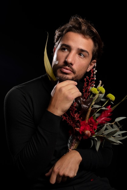 Free photo young and sensitive man with flowers